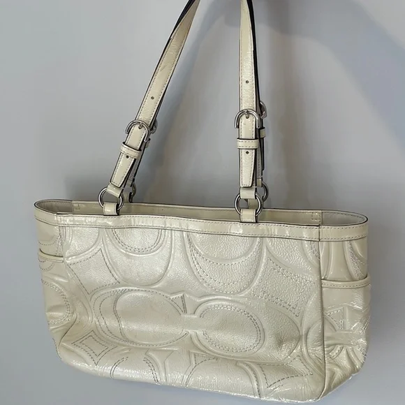 Cream colored patent leather COACH purse
